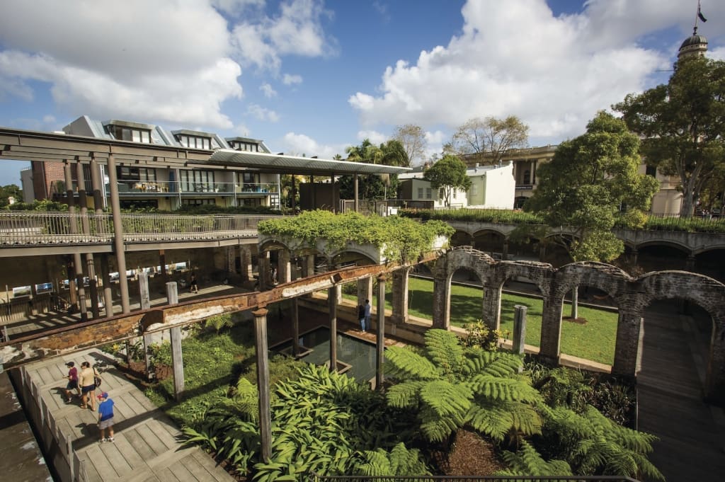 Visitors walking in Paddington Reservoir Gardens in Sydney.